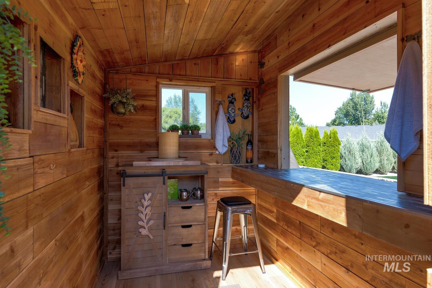 10585 West Vega Court Star, ID 83669 - Photo 40 of 49 Bar with vaulted ceiling, wooden ceiling, wood walls, and wood finished floors