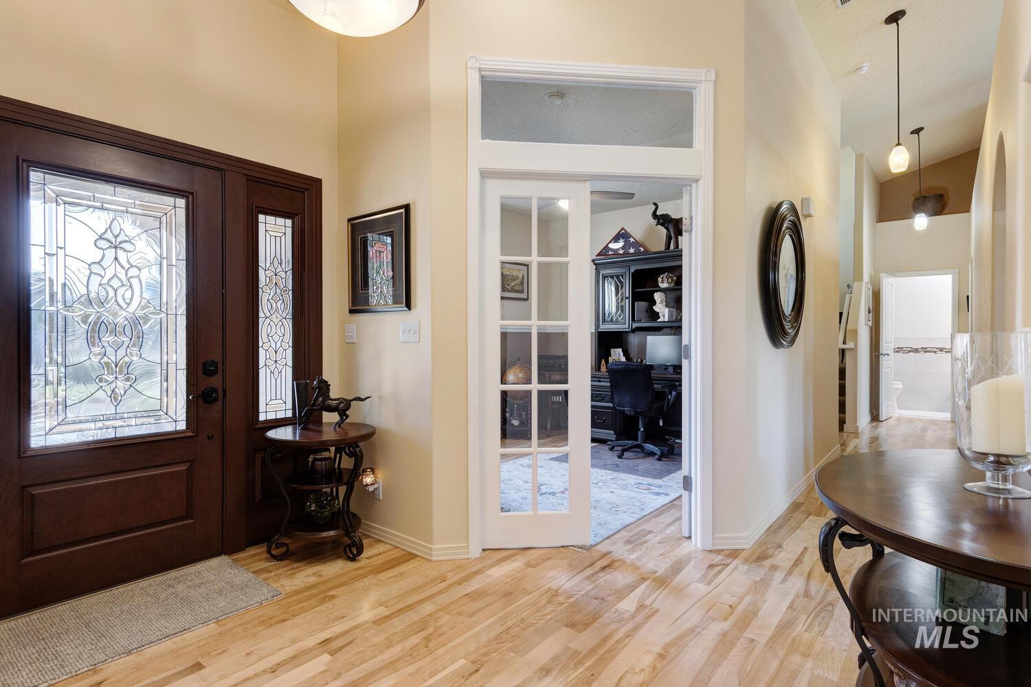 10585 West Vega Court Star, ID 83669 - Photo 4 of 49 Foyer entrance with light wood finished floors and vaulted ceiling
