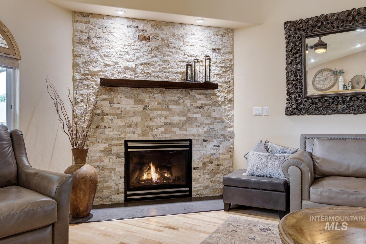 10585 West Vega Court Star, ID 83669 - Photo 8 of 49 Living room with wood finished floors and a glass covered fireplace