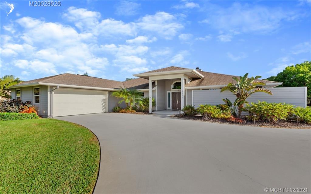 5321 Southeast Sterling Circle Stuart, FL 34997 - Photo 1 of 29 a front view of a house with a garden