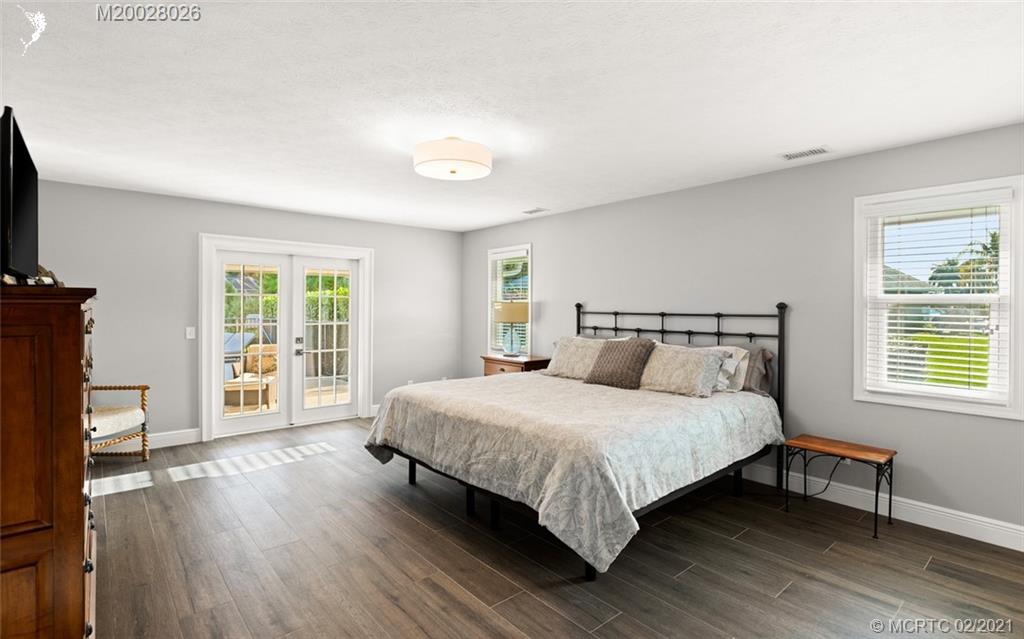 5321 Southeast Sterling Circle Stuart, FL 34997 - Photo 14 of 29 a bedroom with a bed table and a window