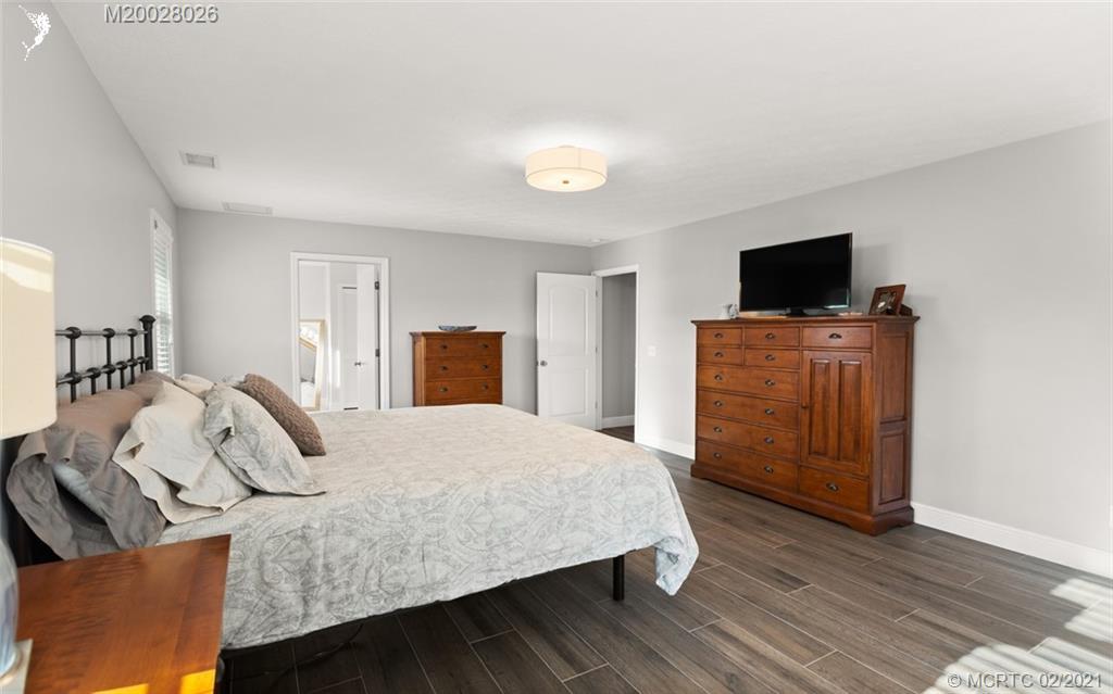 5321 Southeast Sterling Circle Stuart, FL 34997 - Photo 15 of 29 a bedroom with a bed and a flat screen tv