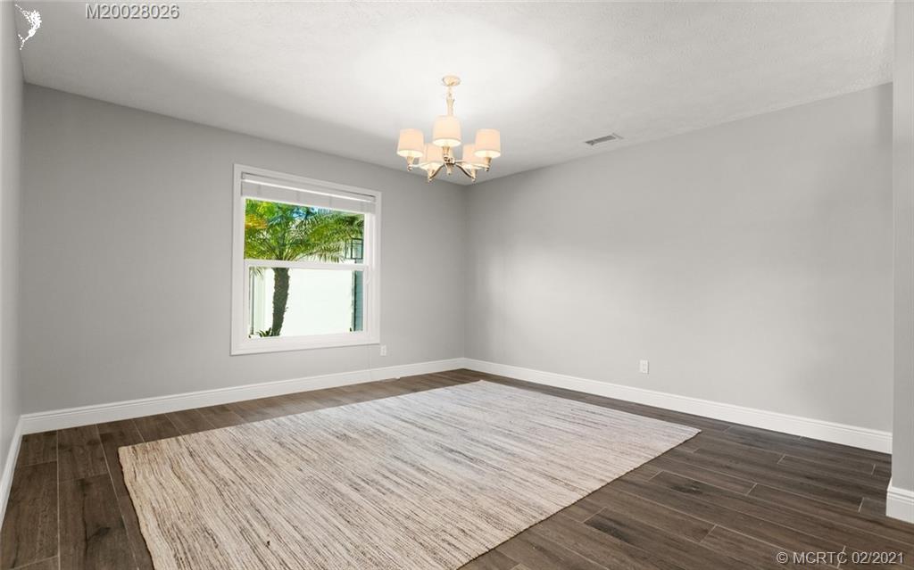5321 Southeast Sterling Circle Stuart, FL 34997 - Photo 18 of 29 a view of a room with wooden floor chandelier and a window