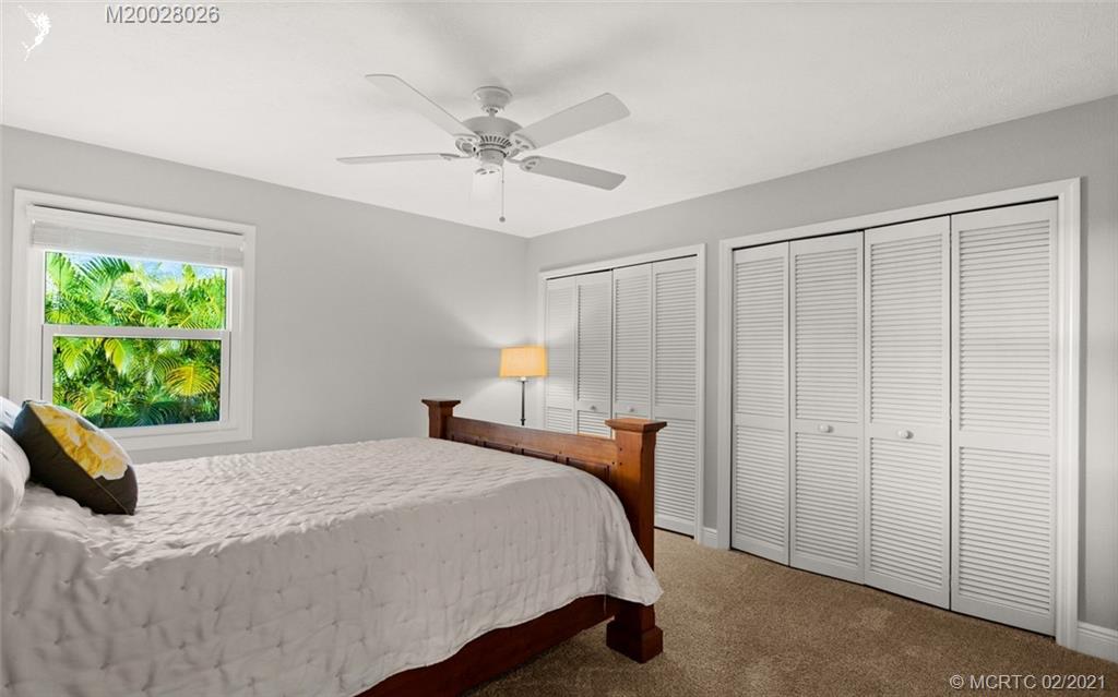 5321 Southeast Sterling Circle Stuart, FL 34997 - Photo 20 of 29 a bedroom with a bed and a window
