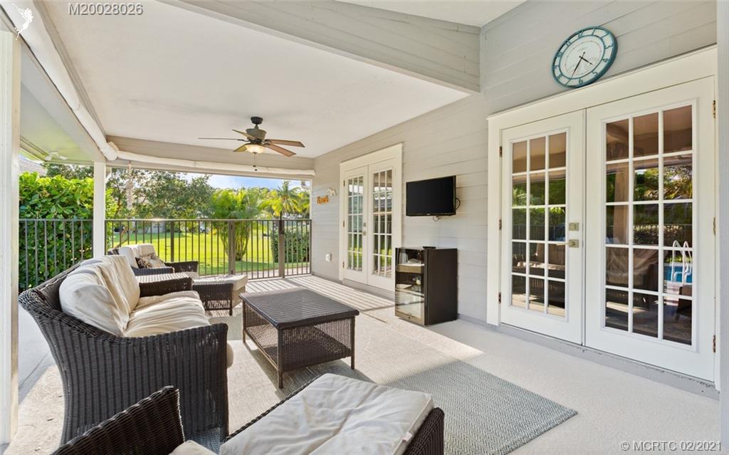 5321 Southeast Sterling Circle Stuart, FL 34997 - Photo 24 of 29 a living room with furniture a fireplace and a large window