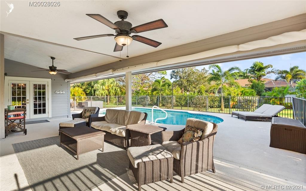 5321 Southeast Sterling Circle Stuart, FL 34997 - Photo 25 of 29 a living room with patio furniture and a large window