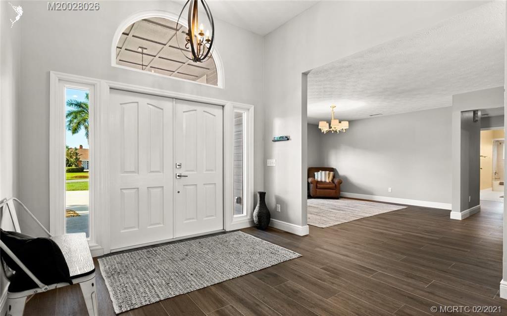 5321 Southeast Sterling Circle Stuart, FL 34997 - Photo 6 of 29 an empty room with wooden floor cabinet and windows