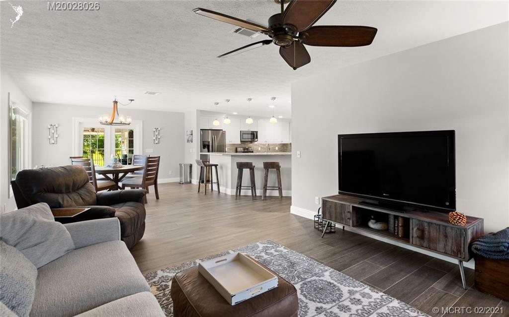 5321 Southeast Sterling Circle Stuart, FL 34997 - Photo 8 of 29 a living room with furniture and a flat screen tv