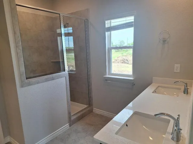 a bathroom with a sink and a window