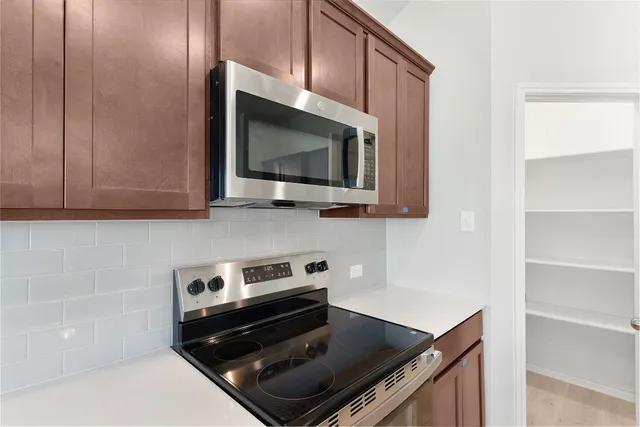 a kitchen with a stove and a microwave