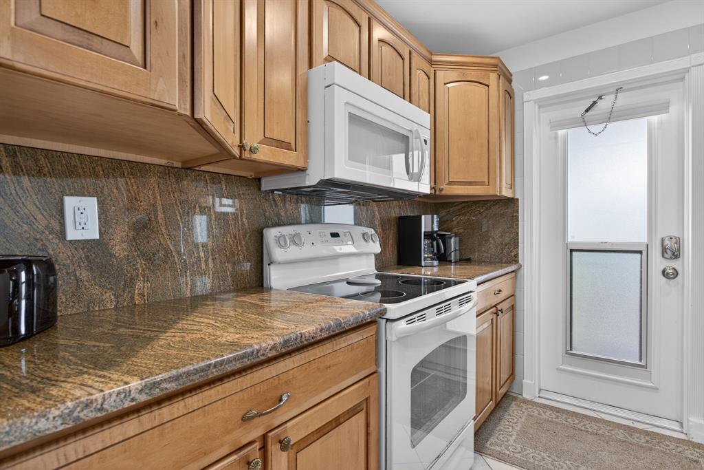 505 North Riverside Drive, Unit 21 Pompano Beach, FL 33062 - Photo 11 of 24 a kitchen with granite countertop cabinets stainless steel appliances and a counter space