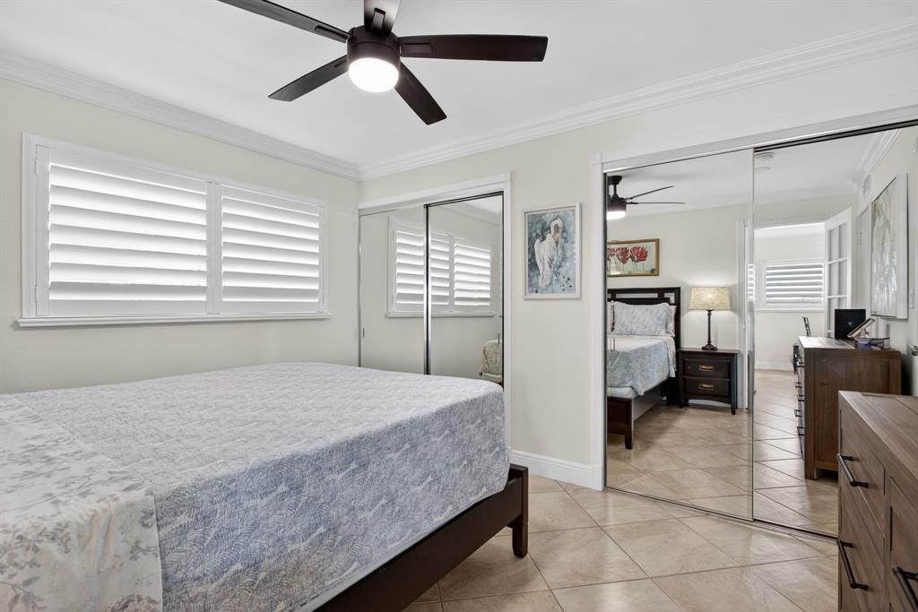 505 North Riverside Drive, Unit 21 Pompano Beach, FL 33062 - Photo 13 of 24 a bedroom with a bed couch and window