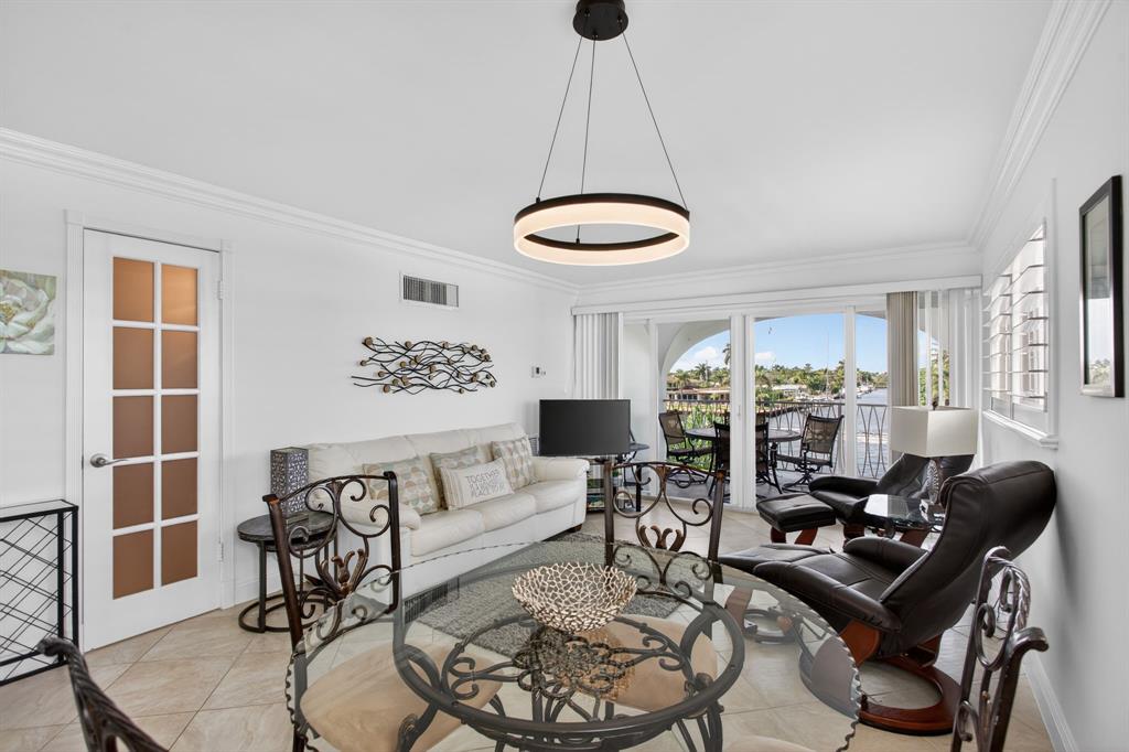 505 North Riverside Drive, Unit 21 Pompano Beach, FL 33062 - Photo 5 of 24 a living room with furniture and a large window