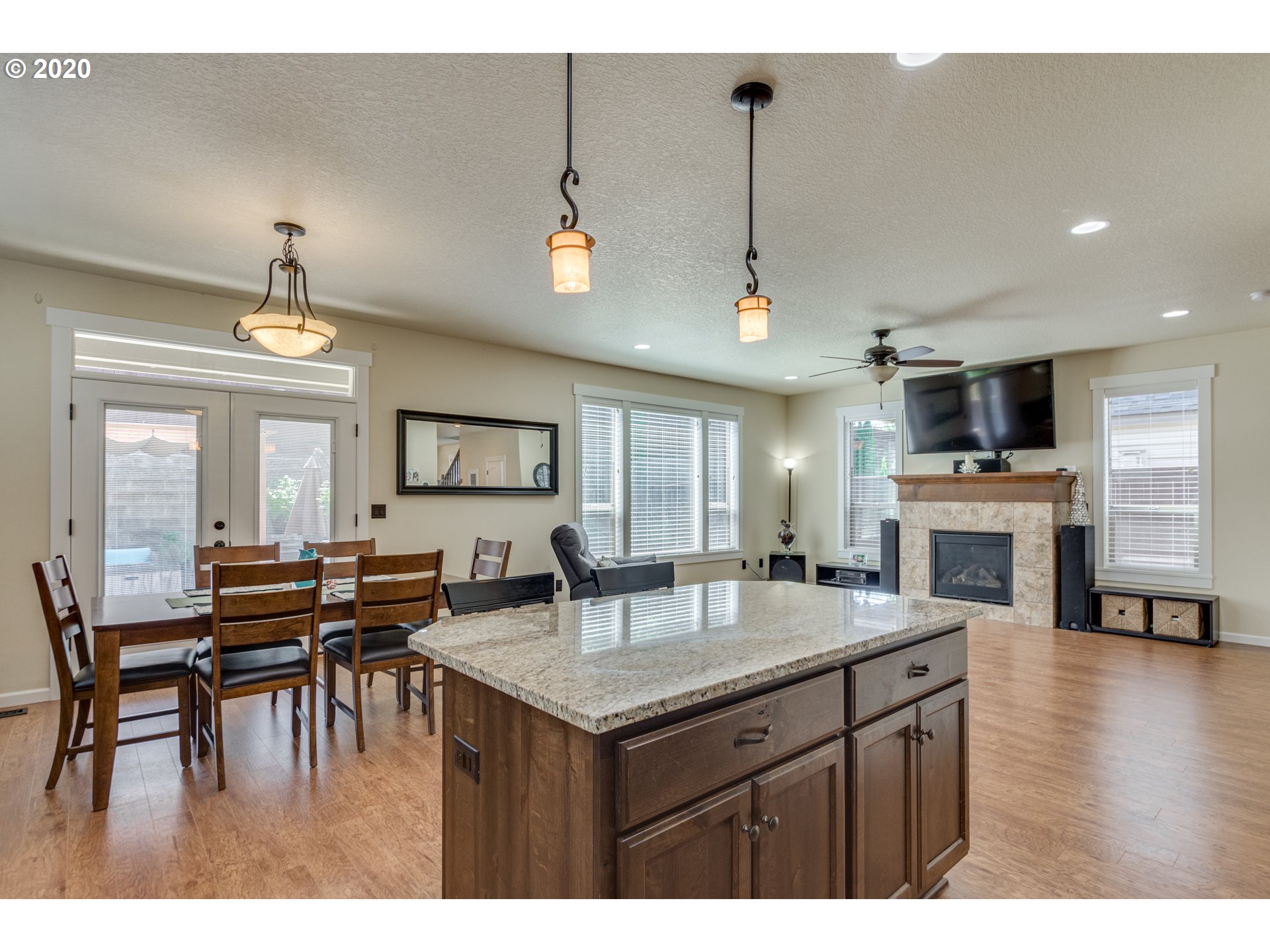 4009 North 5th Way Ridgefield, WA 98642 - Photo 11 of 32 a dining hall with stainless steel appliances granite countertop a stove kitchen island a dining table and chairs