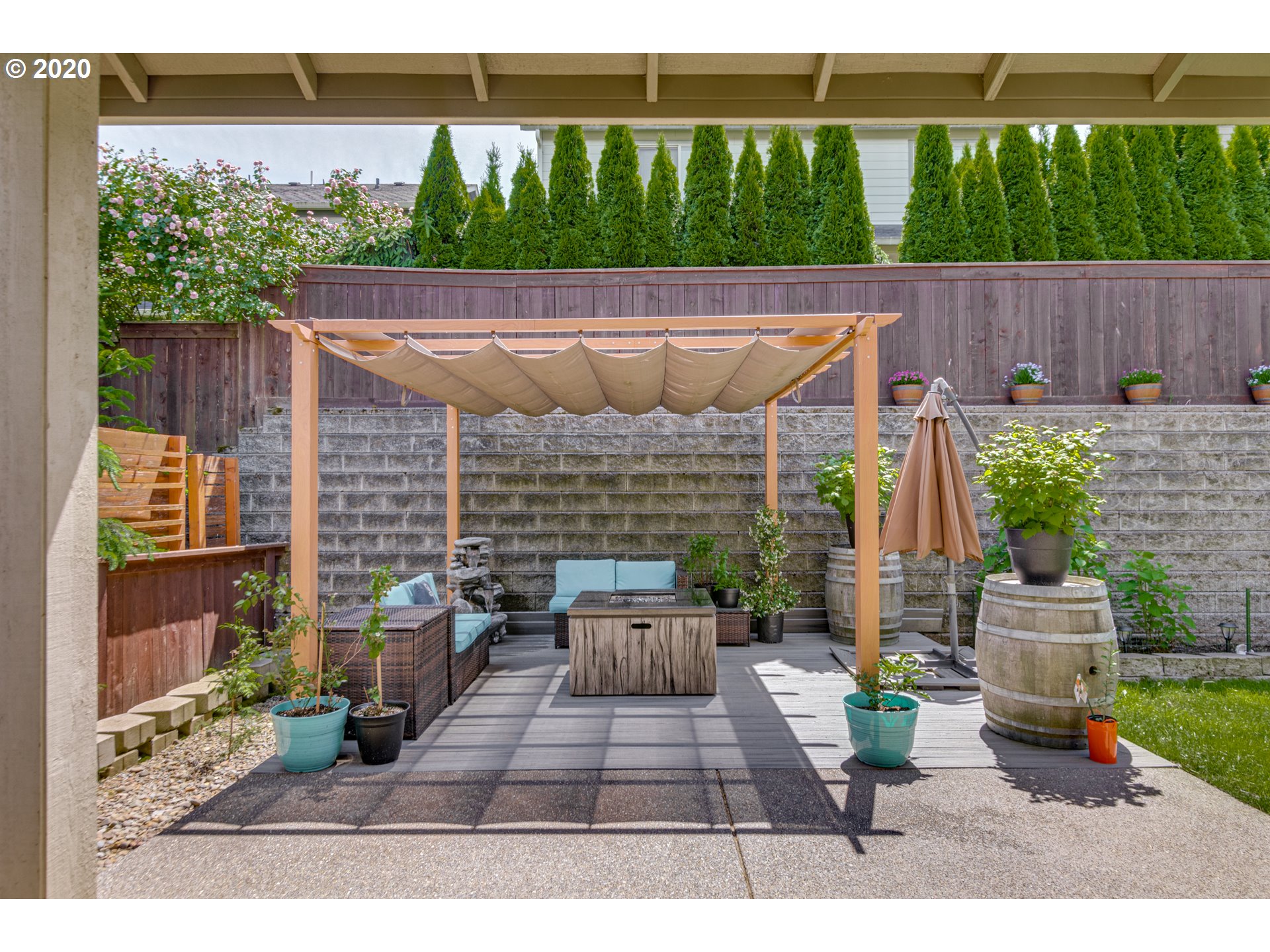 4009 North 5th Way Ridgefield, WA 98642 - Photo 22 of 32 a view of a patio with table and chairs potted plants with wooden floor