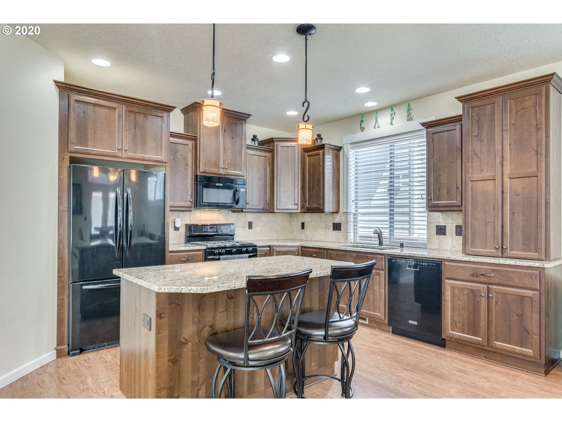 4009 North 5th Way Ridgefield, WA 98642 - Photo 9 of 32 a kitchen with stainless steel appliances granite countertop a sink a stove a refrigerator and island