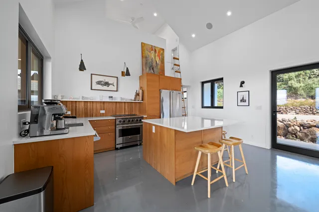 a kitchen with granite countertop a stove and a refrigerator