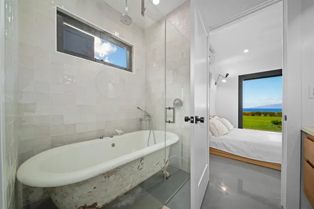 a view of a bedroom with furniture and floor to ceiling window
