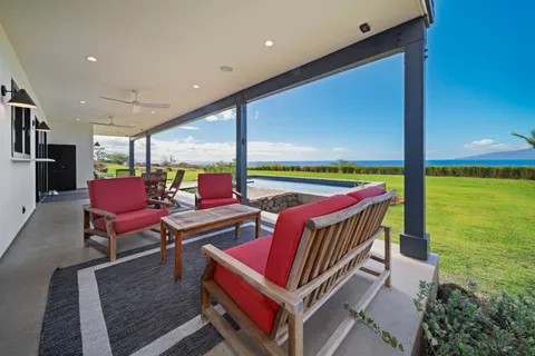 a dining room with furniture and a floor to ceiling window