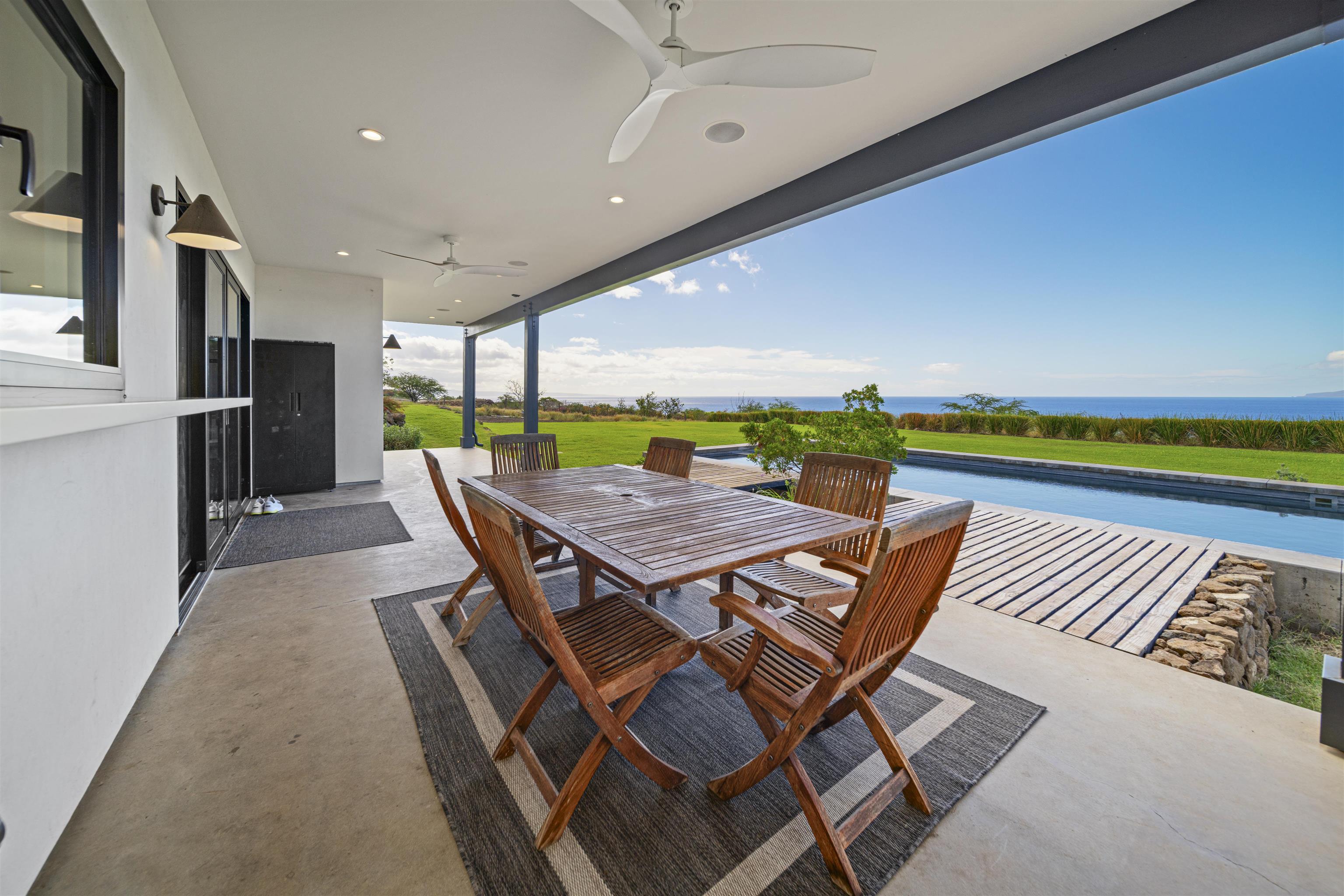 153 Haniu Street, Unit B Lahaina, HI 96761 - Photo 26 of 41 a dining room with furniture and a floor to ceiling window