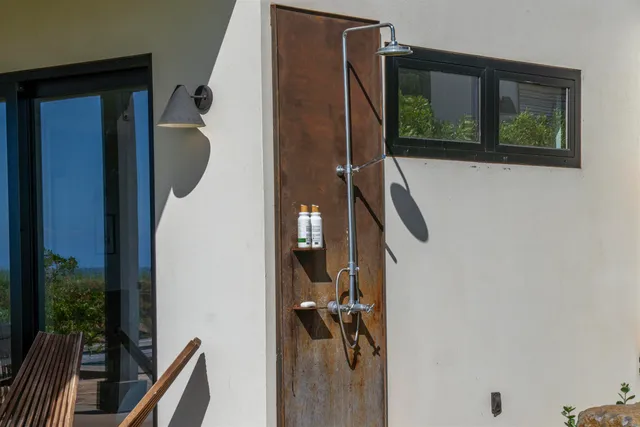 a bedroom with a bed and large window