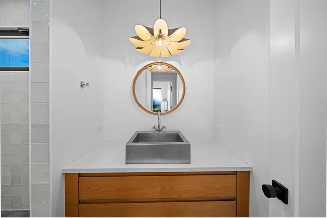 a bathroom with a shower and a sink