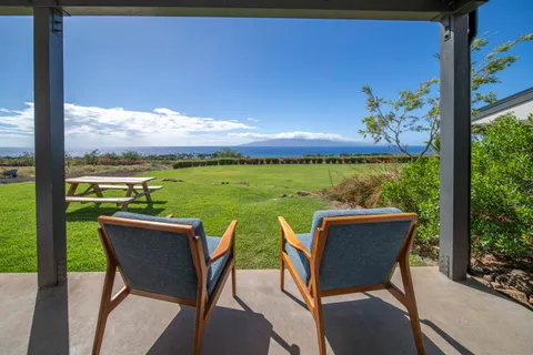 a view of a two chairs in the garden