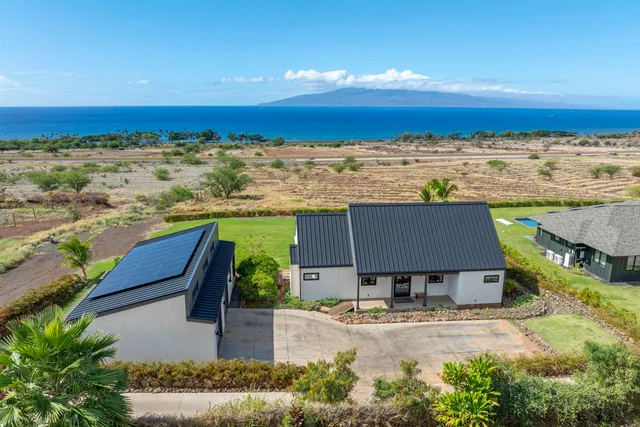 an aerial view of a house with ocean view