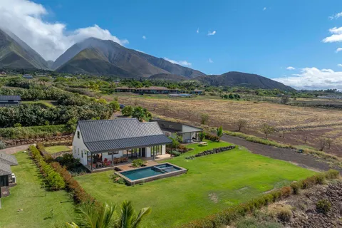 a view of a house with yard and lake view