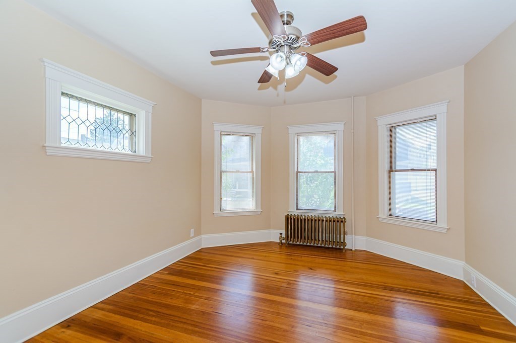 31 Morris Street Everett, MA 02149 - Photo 11 of 42 a view of an empty room with wooden floor and a window