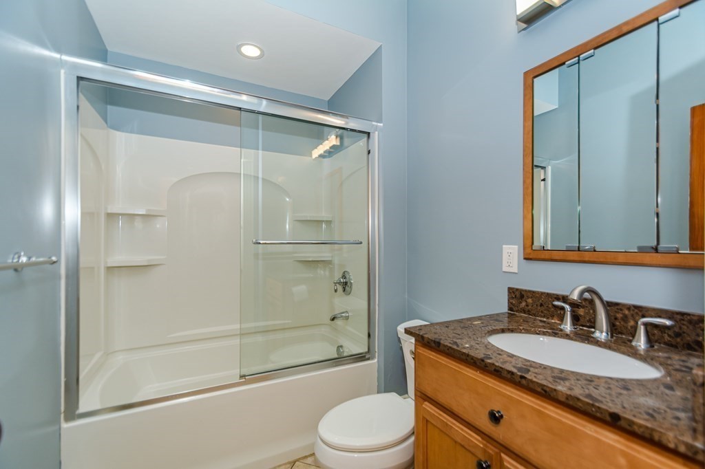 31 Morris Street Everett, MA 02149 - Photo 17 of 42 a bathroom with a granite countertop sink toilet mirror and shower