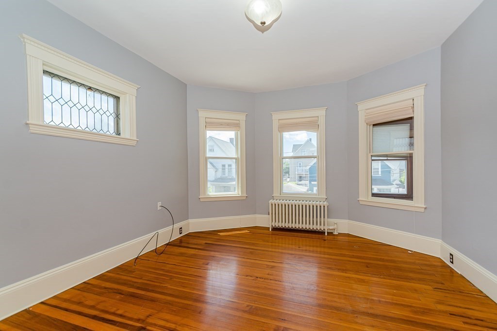 31 Morris Street Everett, MA 02149 - Photo 20 of 42 a view of empty room with wooden floor and fan