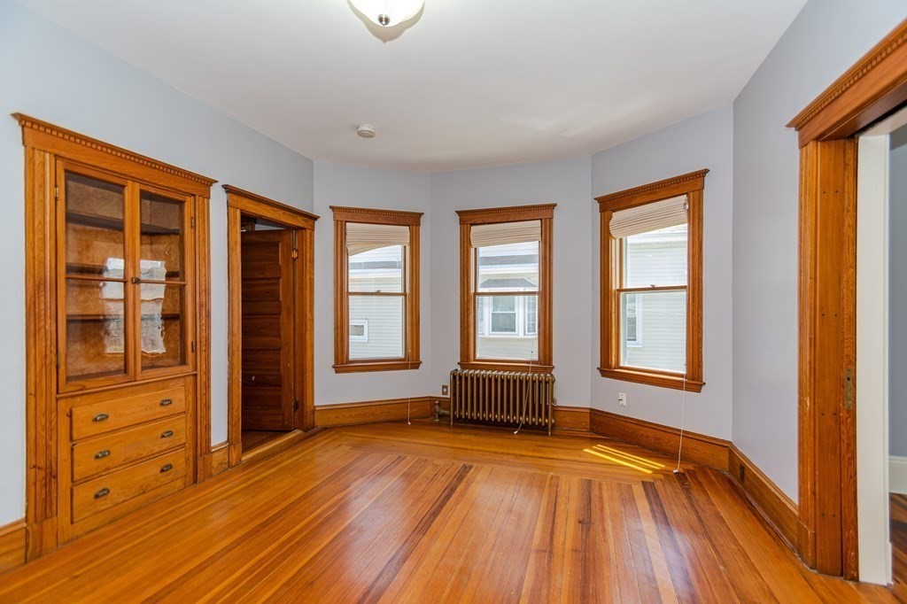 31 Morris Street Everett, MA 02149 - Photo 21 of 42 an empty room with wooden floor and windows