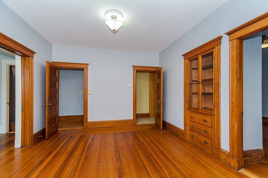 31 Morris Street Everett, MA 02149 - Photo 22 of 42 wooden floor in an empty room with a window