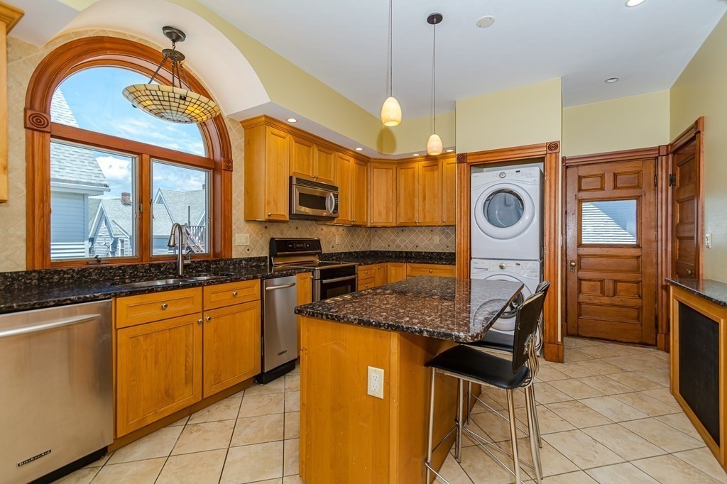 31 Morris Street Everett, MA 02149 - Photo 24 of 42 a kitchen with stainless steel appliances granite countertop a stove a sink and a refrigerator