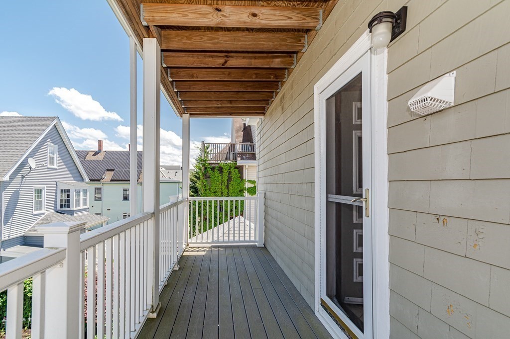 31 Morris Street Everett, MA 02149 - Photo 26 of 42 a view of a porch with wooden floor and iron stairs