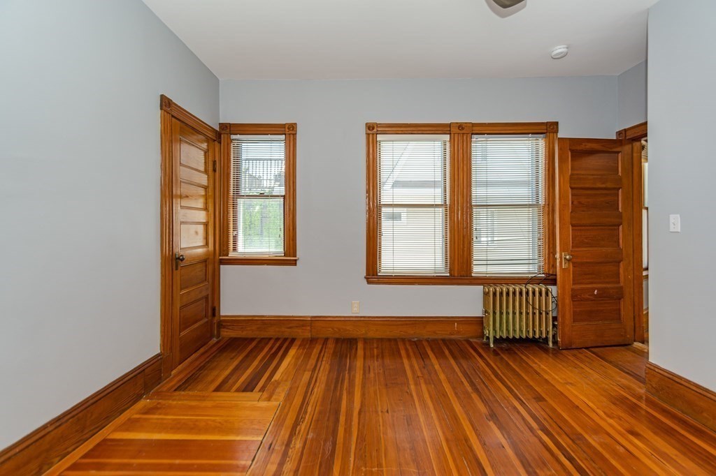 31 Morris Street Everett, MA 02149 - Photo 28 of 42 an empty room with wooden floor and windows