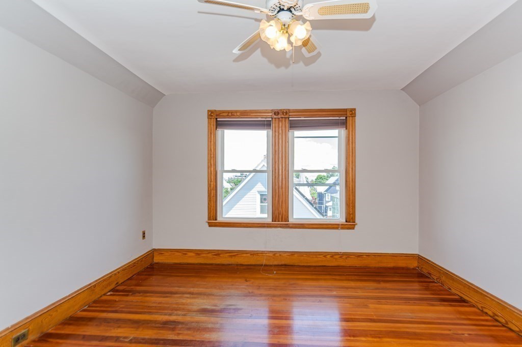 31 Morris Street Everett, MA 02149 - Photo 33 of 42 a view of an empty room with wooden floor and a window