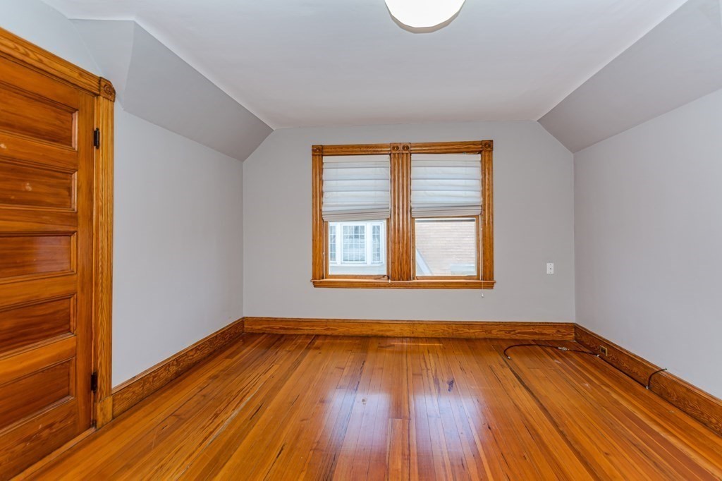 31 Morris Street Everett, MA 02149 - Photo 35 of 42 a view of an empty room with wooden floor and a window