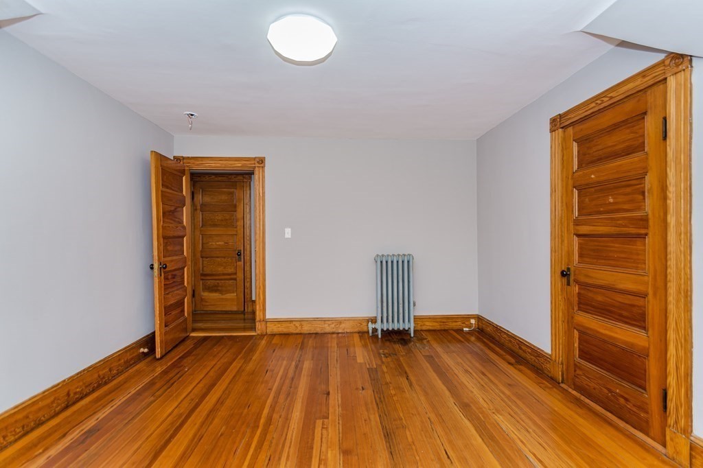 31 Morris Street Everett, MA 02149 - Photo 36 of 42 a view of empty room with wooden floor