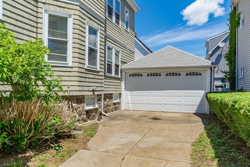 31 Morris Street Everett, MA 02149 - Photo 7 of 42 a front view of a house with a garden