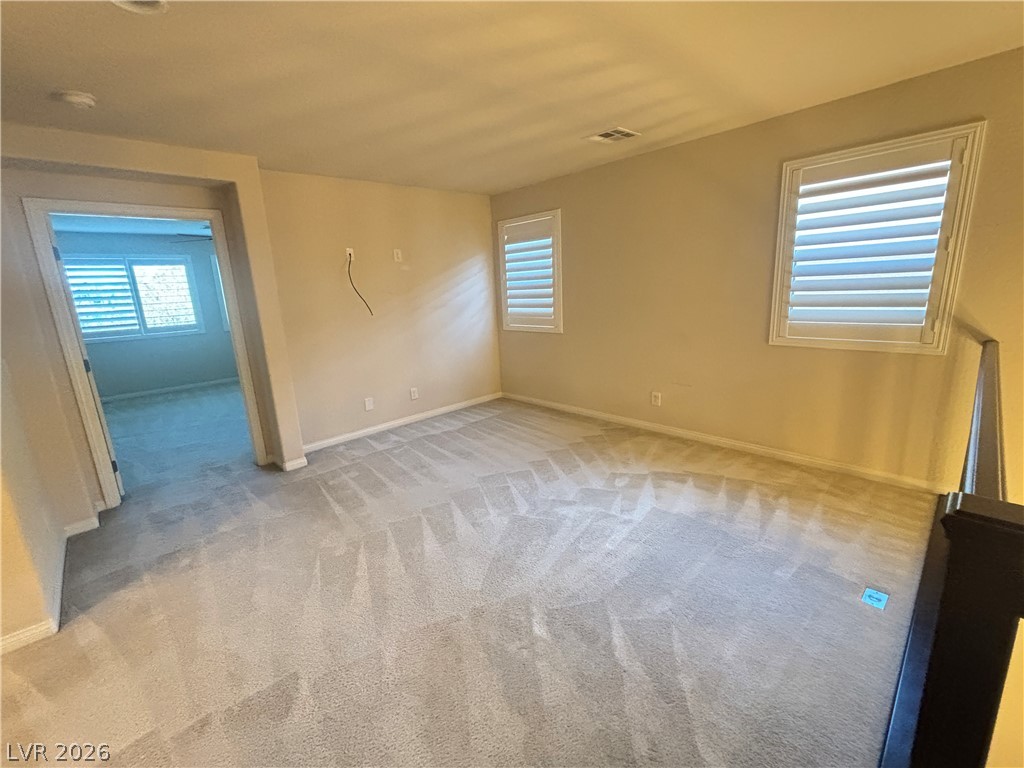 121 Elm Reed Avenue Las Vegas, NV 89113 - Photo 17 of 30 A versatile bonus room with plush carpeting and natural light offers an ideal flexible space.