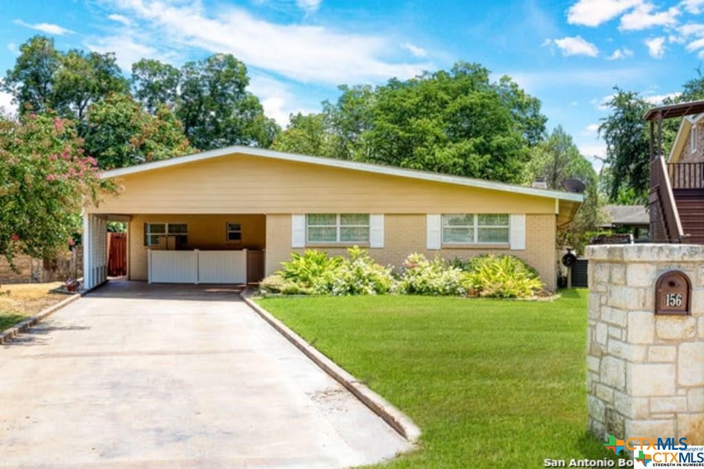 a front view of a house with a garden and yard