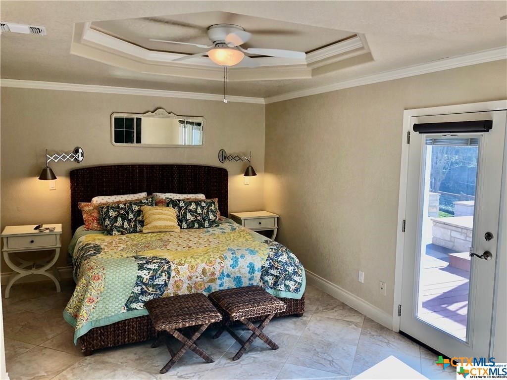 156 Trelawney Street McQueeney, TX 78123 - Photo 9 of 13 a bedroom with a bed and a table in it