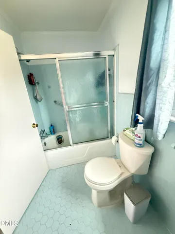 a bathroom with a double vanity sink toilet mirror and bathtub