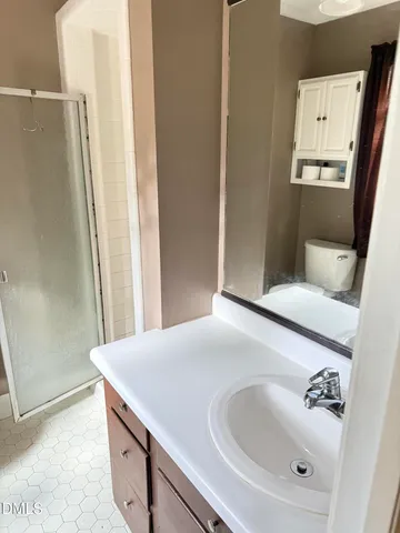 a bathroom with a granite countertop toilet sink and tub