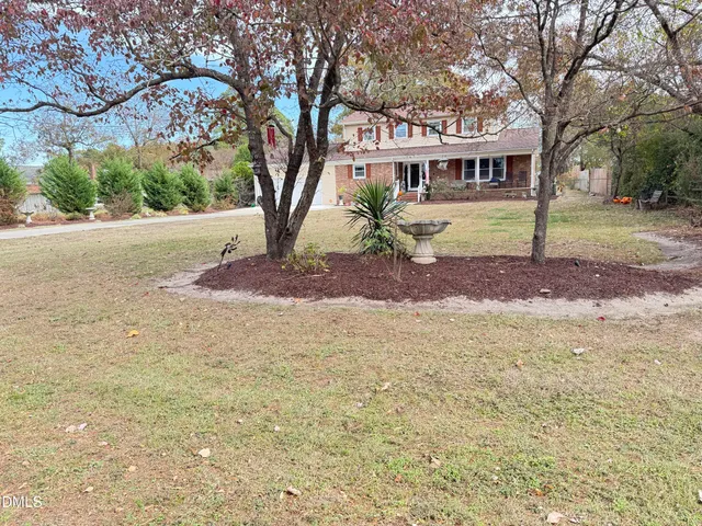 a view of a patio with table and chairs potted plants