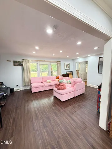 a view of a livingroom with an empty space and a window