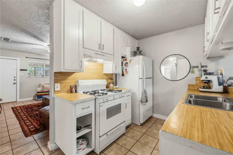 a kitchen with stainless steel appliances a stove a sink and a refrigerator