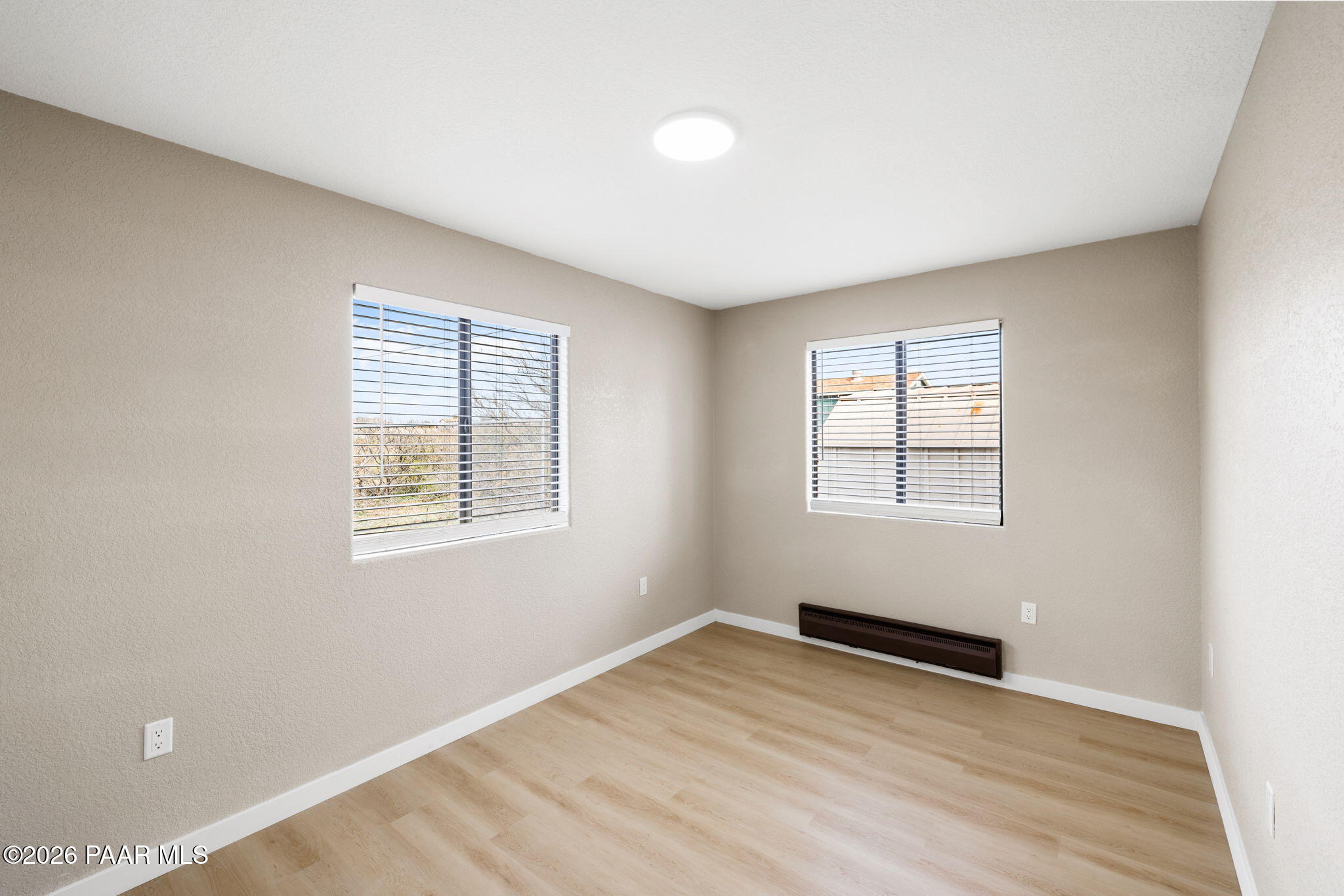 20102 East Antelope Road Mayer, AZ 86333 - Photo 17 of 24 an empty room with wooden floor and windows